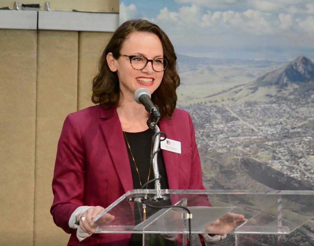 Jane Pomeroy, Chief Communications Officer speaking at a podium at an event.