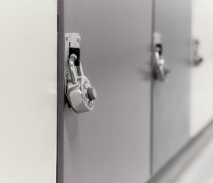 Gray and white picture of lockers with locks on them.